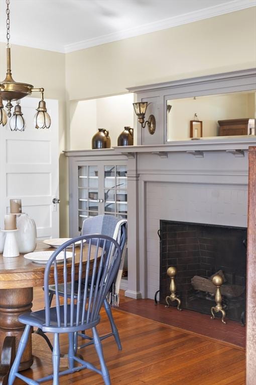 6 Francis Circuit Unit 6, Winchester, MA 01890 - dining area with ornamental molding, wood finished floors, and a fireplace with flush hearth