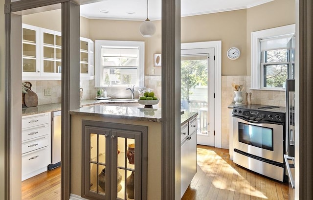 6 Francis Circuit Unit 6, Winchester, MA 01890 - kitchen featuring stainless steel range with electric stovetop, white cabinetry, glass insert cabinets, light wood-style flooring, and ornamental molding