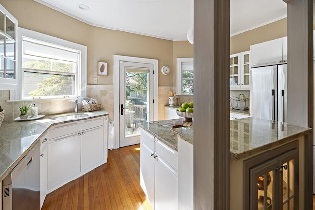 6 Francis Circuit Unit 6, Winchester, MA 01890 - kitchen featuring appliances with stainless steel finishes, a sink, glass insert cabinets, backsplash, and crown molding