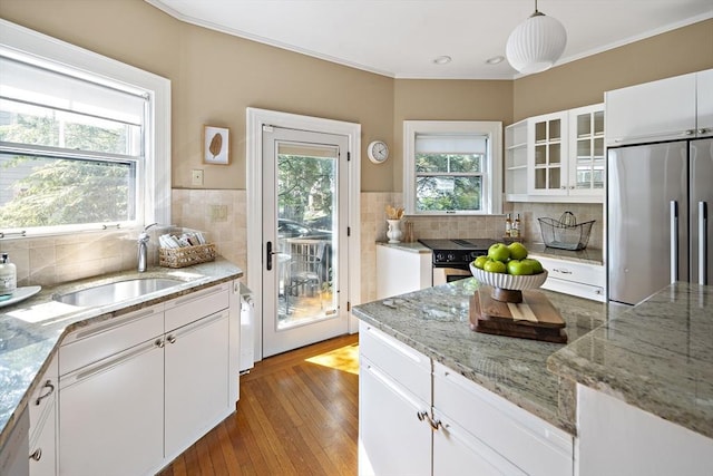 6 Francis Circuit Unit 6, Winchester, MA 01890 - kitchen with stainless steel appliances, a sink, wood finished floors, white cabinets, and ornamental molding