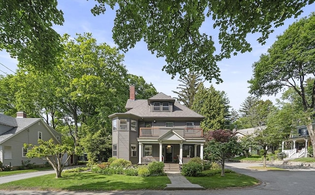 6 Francis Circuit Unit 6, Winchester, MA 01890 - view of front facade with a balcony, covered porch, a front yard, and a chimney