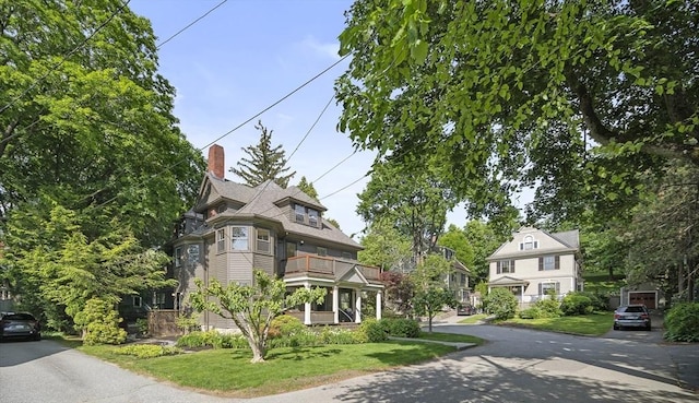 6 Francis Circuit Unit 6, Winchester, MA 01890 - view of front of house with a balcony, a chimney, and a front yard