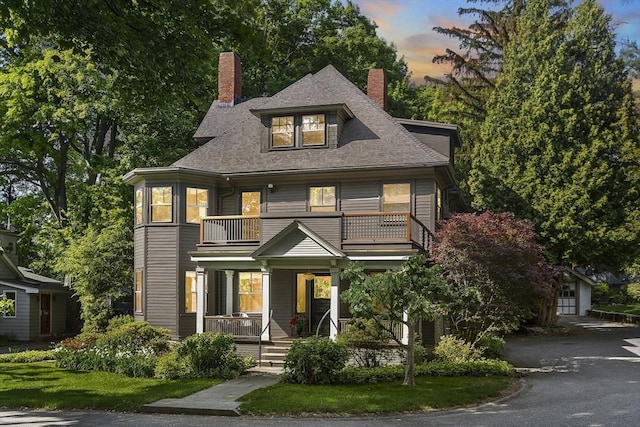 6 Francis Circuit Unit 6, Winchester, MA 01890 - view of front of house featuring a balcony, a porch, a chimney, roof with shingles, and asphalt driveway