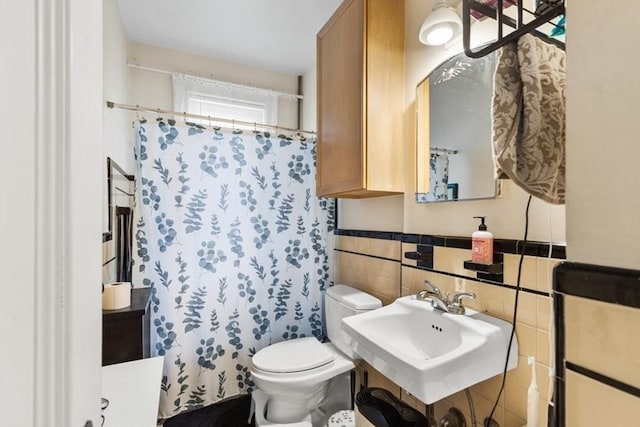126 W Wyoming Ave, Melrose, MA 02176 - bathroom featuring toilet, a sink, tile walls, and curtained shower