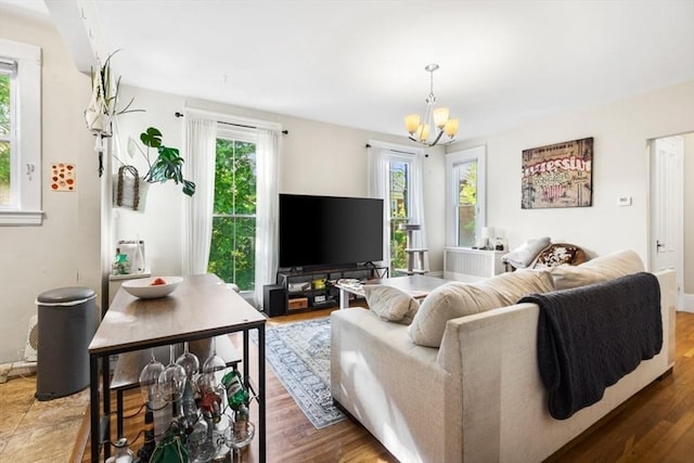 126 W Wyoming Ave, Melrose, MA 02176 - living room with plenty of natural light, a chandelier, and wood finished floors