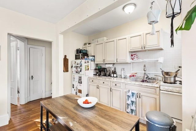 126 W Wyoming Ave, Melrose, MA 02176 - kitchen featuring white appliances, a sink, wood finished floors, light countertops, and backsplash
