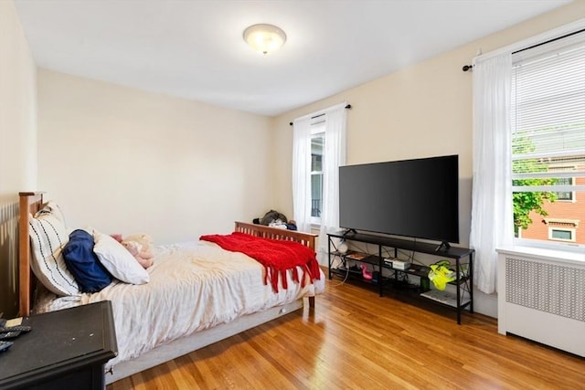 126 W Wyoming Ave, Melrose, MA 02176 - bedroom featuring radiator heating unit and wood finished floors
