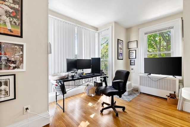 126 W Wyoming Ave, Melrose, MA 02176 - office area with wood finished floors, baseboards, and radiator heating unit