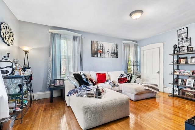 126 W Wyoming Ave, Melrose, MA 02176 - living area featuring healthy amount of natural light, hardwood / wood-style flooring, and baseboards