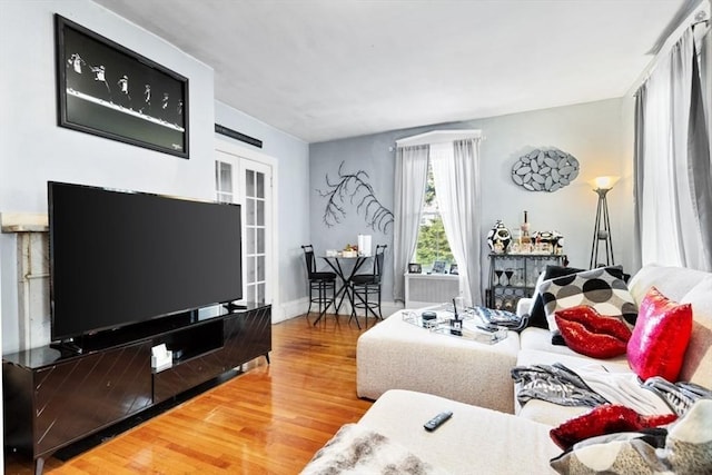 126 W Wyoming Ave, Melrose, MA 02176 - living area with wood finished floors, french doors, and baseboards