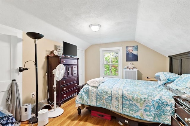 126 W Wyoming Ave, Melrose, MA 02176 - bedroom with a textured ceiling, light wood-type flooring, and lofted ceiling