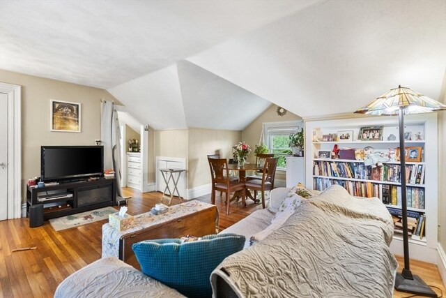 126 W Wyoming Ave, Melrose, MA 02176 - living area with wood finished floors, vaulted ceiling, and baseboards