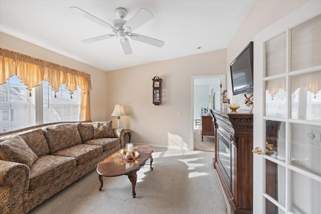 carpeted living room featuring ceiling fan