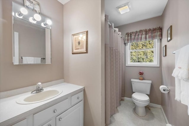 bathroom featuring vanity, curtained shower, and toilet