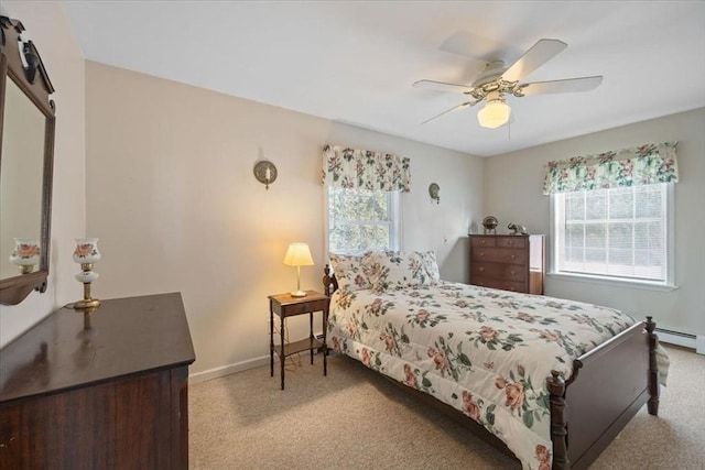 bedroom featuring multiple windows, light carpet, a barn door, and ceiling fan