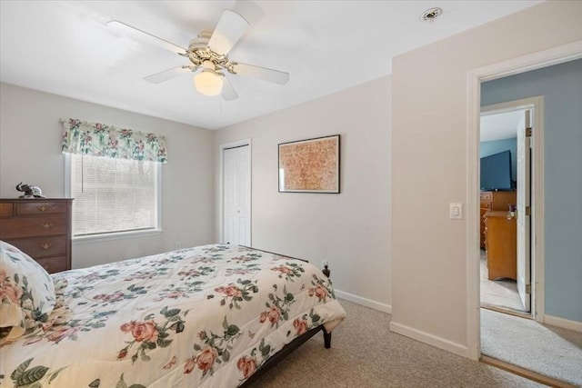 bedroom featuring light carpet, ceiling fan, and a closet