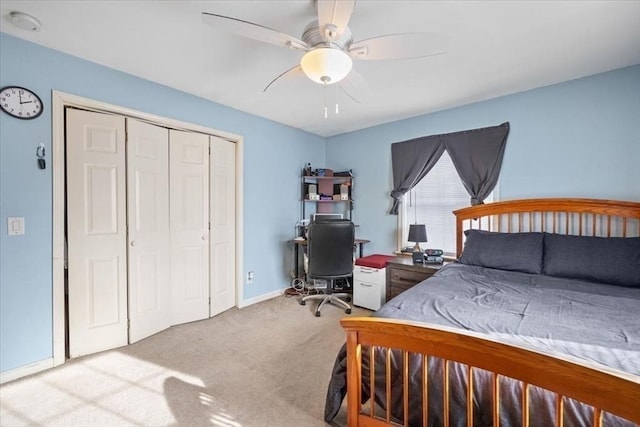 carpeted bedroom with a closet and ceiling fan