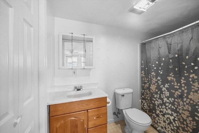 bathroom featuring vanity, toilet, and curtained shower