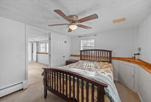 carpeted bedroom with multiple windows, a baseboard radiator, and ceiling fan