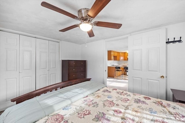 bedroom with ceiling fan and a closet