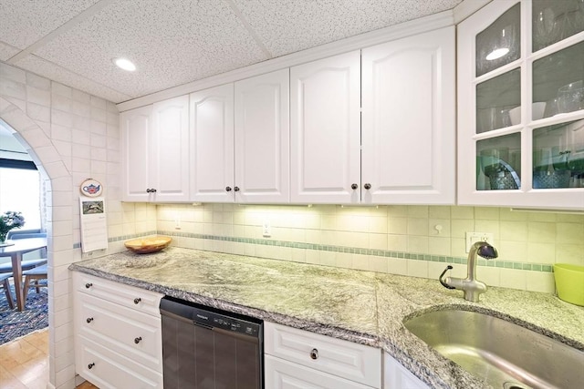 61 Broad Reach Unit T62B, Weymouth, MA 02191 - kitchen with dishwashing machine, a sink, glass insert cabinets, light stone counters, and white cabinetry