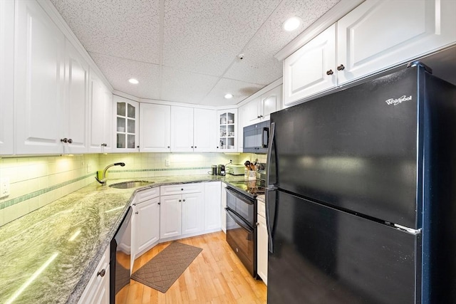 61 Broad Reach Unit T62B, Weymouth, MA 02191 - kitchen with black appliances, a sink, glass insert cabinets, light wood-type flooring, and white cabinetry