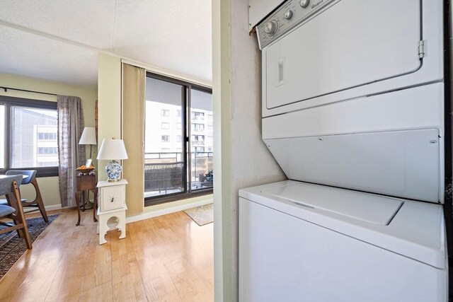 61 Broad Reach Unit T62B, Weymouth, MA 02191 - washroom with stacked washer / drying machine, light wood-style floors, and baseboards