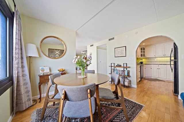 61 Broad Reach Unit T62B, Weymouth, MA 02191 - dining area with light wood-type flooring, baseboards, and arched walkways