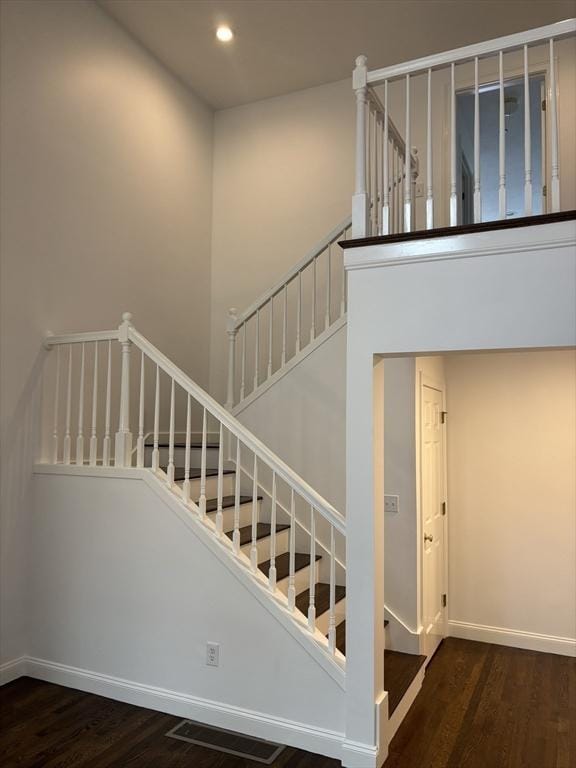 stairway with recessed lighting, baseboards, visible vents, and wood finished floors