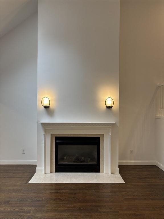 interior details with baseboards, wood finished floors, and a fireplace