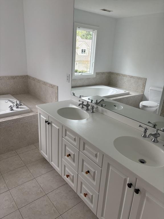 bathroom featuring visible vents, tile patterned flooring, a sink, and a bath