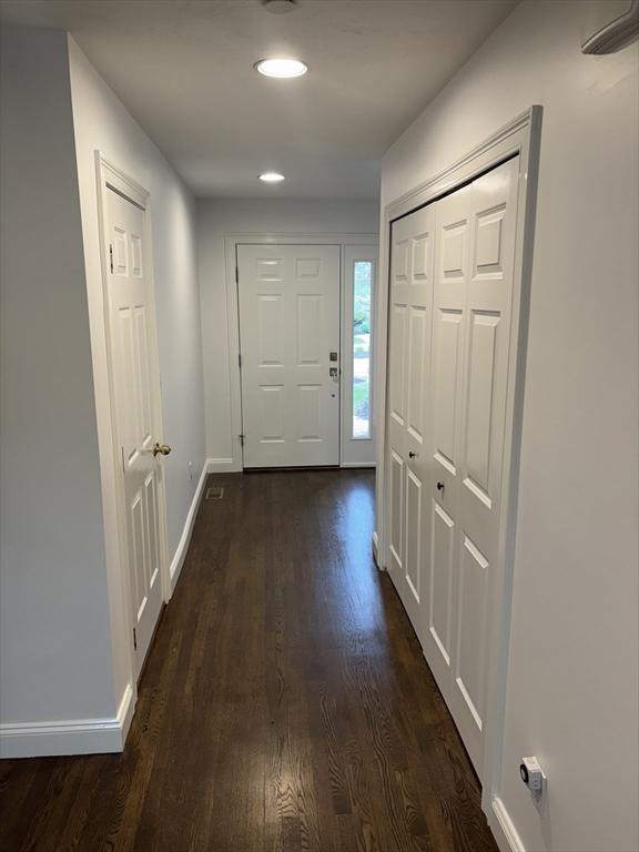 doorway featuring recessed lighting, baseboards, and dark wood-style floors