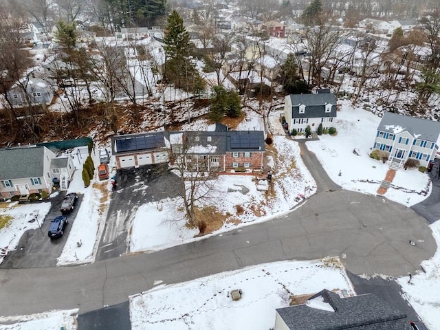 snowy aerial view with a residential view