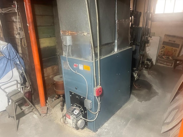 utility room featuring heating unit