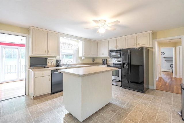 19 Zabelle Ave, Auburn, MA 01501 - kitchen with black appliances, baseboard heating, a sink, ceiling fan, and light countertops
