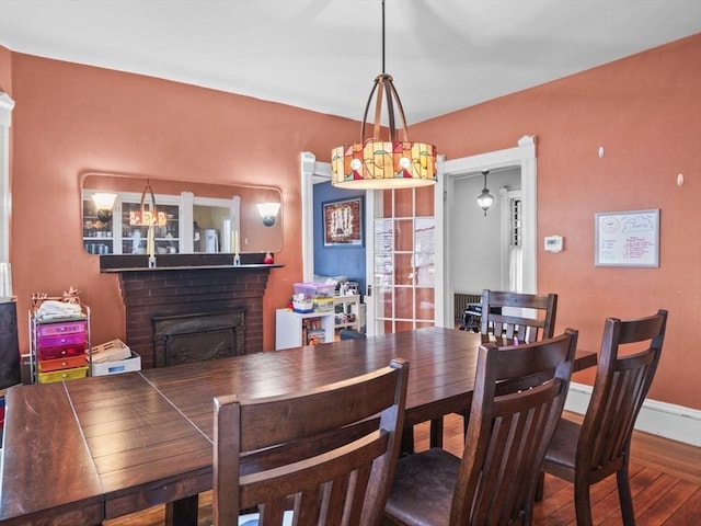 743 Bridge St, Lowell, MA 01850 - dining area featuring a fireplace and hardwood / wood-style flooring