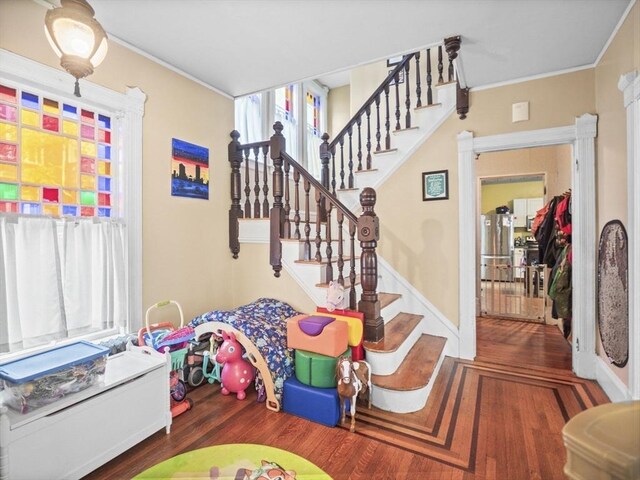 743 Bridge St, Lowell, MA 01850 - stairway featuring wood finished floors, crown molding, and healthy amount of natural light