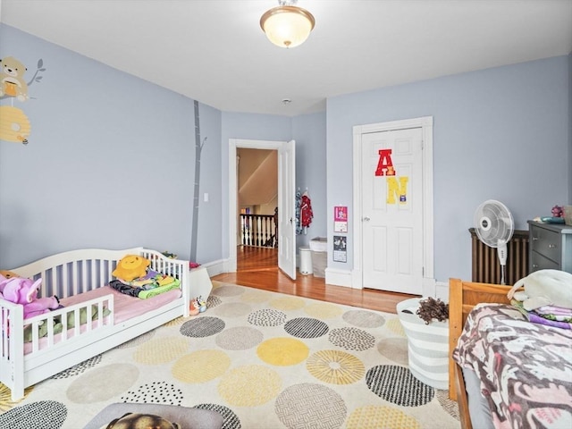 743 Bridge St, Lowell, MA 01850 - bedroom with radiator heating unit and wood finished floors