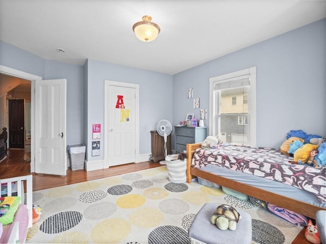 743 Bridge St, Lowell, MA 01850 - bedroom with wood finished floors and radiator