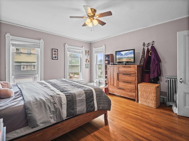 743 Bridge St, Lowell, MA 01850 - bedroom featuring radiator heating unit, light wood-type flooring, ceiling fan, and ornamental molding