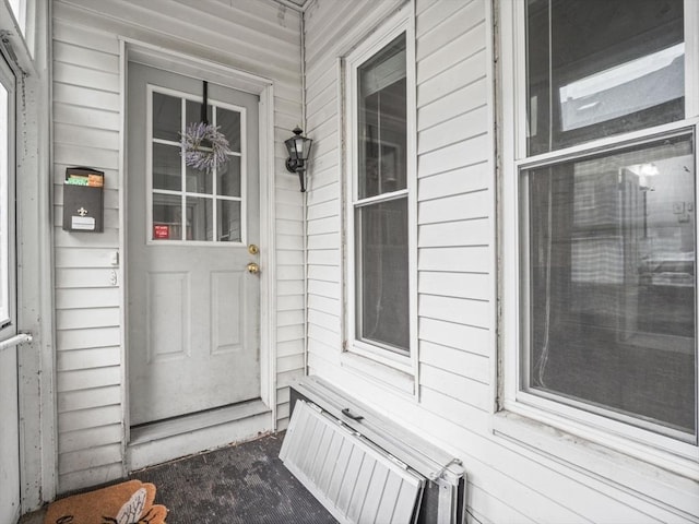 743 Bridge St, Lowell, MA 01850 - doorway to property featuring a porch