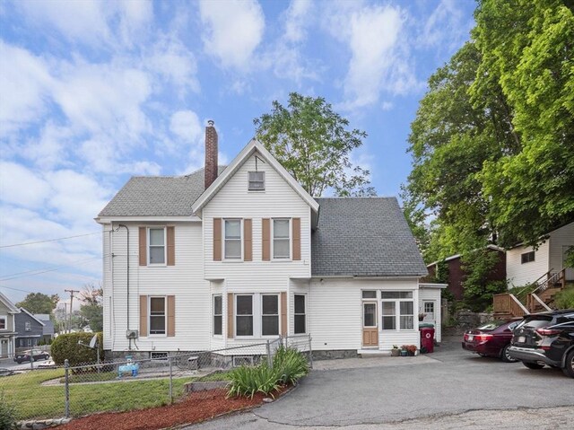 743 Bridge St, Lowell, MA 01850 - view of front of property with a chimney and roof with shingles