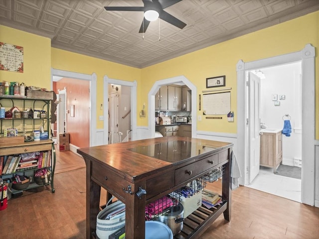 743 Bridge St, Lowell, MA 01850 - office featuring an ornate ceiling, a ceiling fan, light wood-style flooring, and a wainscoted wall