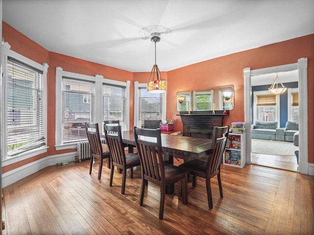 743 Bridge St, Lowell, MA 01850 - dining space featuring wood-type flooring and radiator heating unit