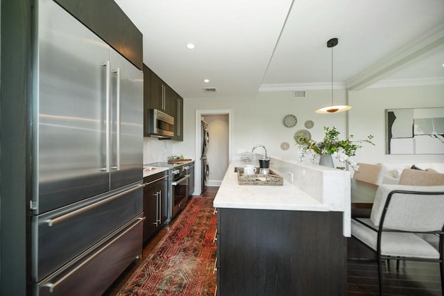 56 Commonwealth Ave Ph, Ph, Boston, MA 02116 - kitchen featuring stainless steel appliances, light countertops, a sink, dark wood finished floors, and pendant lighting
