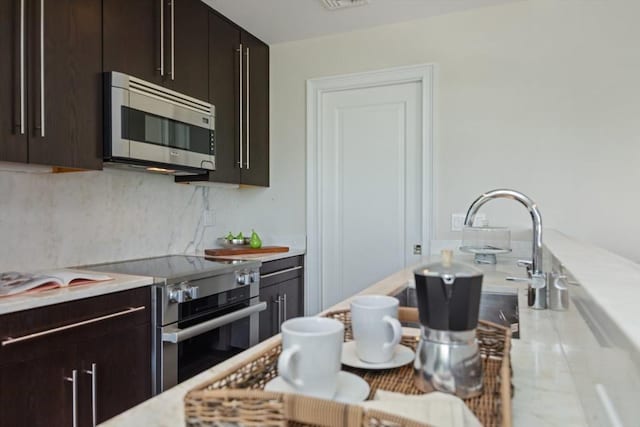 56 Commonwealth Ave Ph, Ph, Boston, MA 02116 - kitchen featuring appliances with stainless steel finishes, light countertops, tasteful backsplash, and dark brown cabinetry