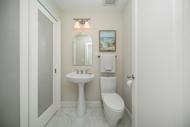 56 Commonwealth Ave Ph, Ph, Boston, MA 02116 - bathroom with toilet, marble look tiles, and baseboards