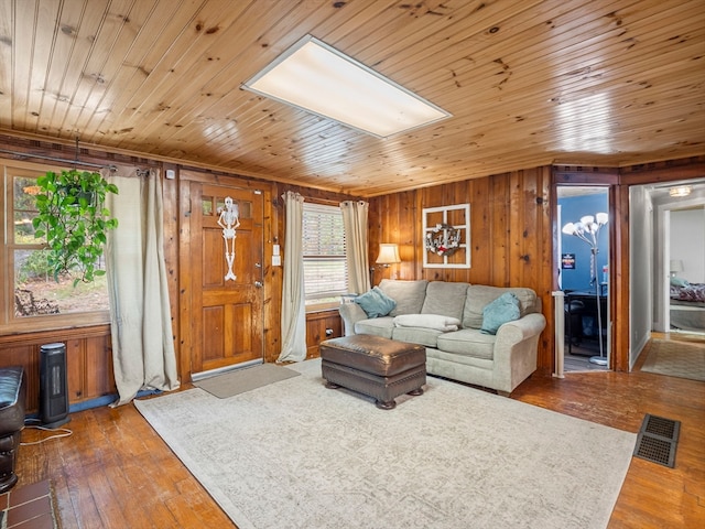 living room with wooden walls, wood ceiling, and dark hardwood / wood-style floors