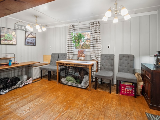 living area featuring light hardwood / wood-style flooring and an inviting chandelier