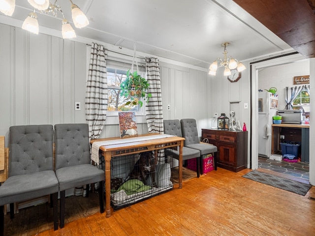 sitting room with a notable chandelier and wood-type flooring